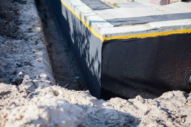 Professional Basement Waterproofing technician working in Uniontown, AL